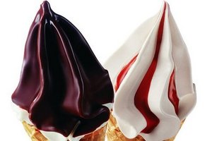 Soft ice cream with chocolate and strawberry sauce