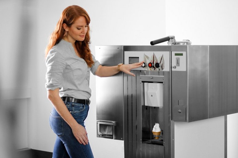 Woman operating soft ice cream machine