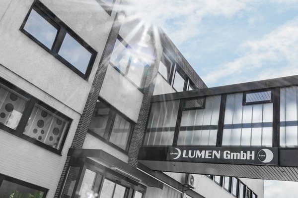 Company building of LUMEN GmbH under a blue sky
