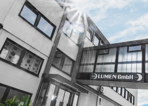 Company building of LUMEN GmbH under a blue sky